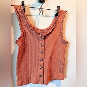 Tank top with buttons down the middle.